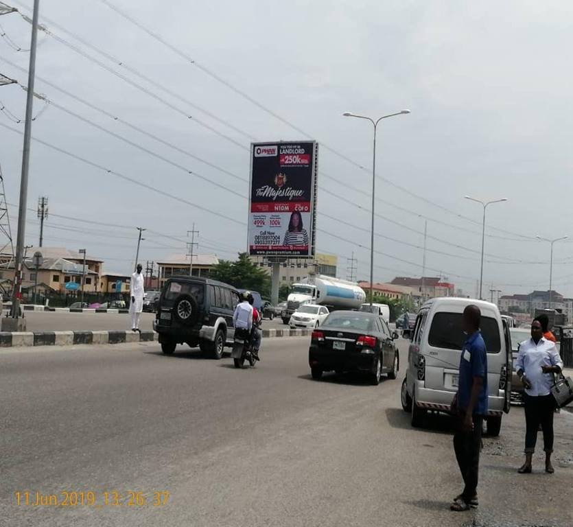 Billboards at Awoyaya Bus Stop displaying advertising along Lekki-Epe Expressway with heavy traffic and high visibility
